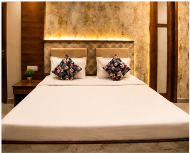Deluxe Room bed with swan towel art at Baibhab Resorts